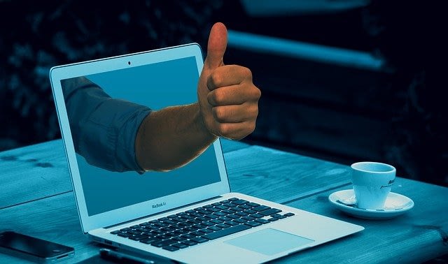 thumbs-up-through-computer-screen